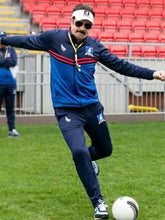 Jason Sudeikis blue track jacket from Ted Lasso